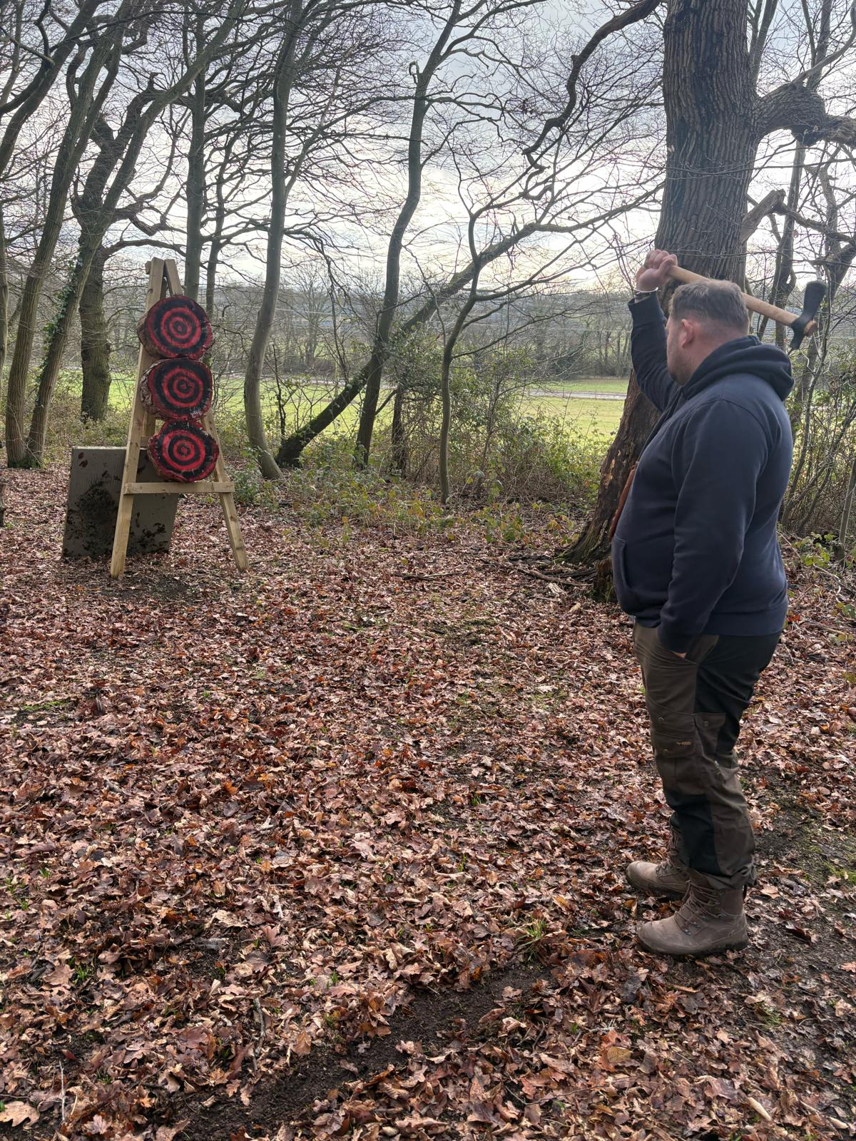 An instructor coaching axe-throwing technique