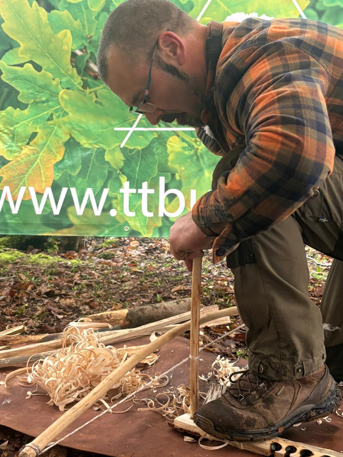 Carving wood by hand, shavings on the ground