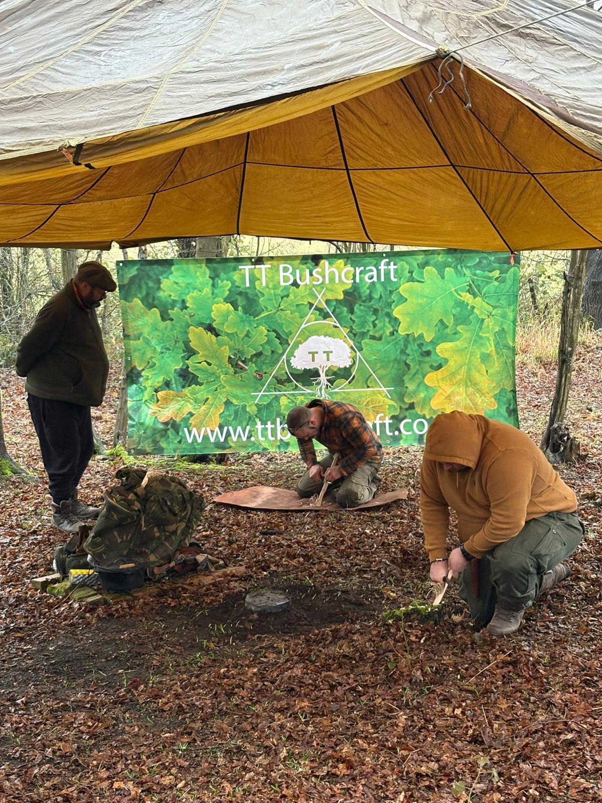 A small group working together at a bushcraft setup